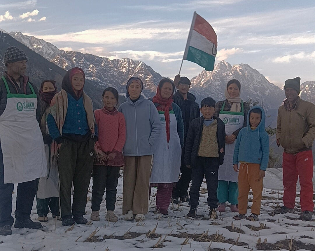 Group of people standing on a snowy landscape with mountains in the background